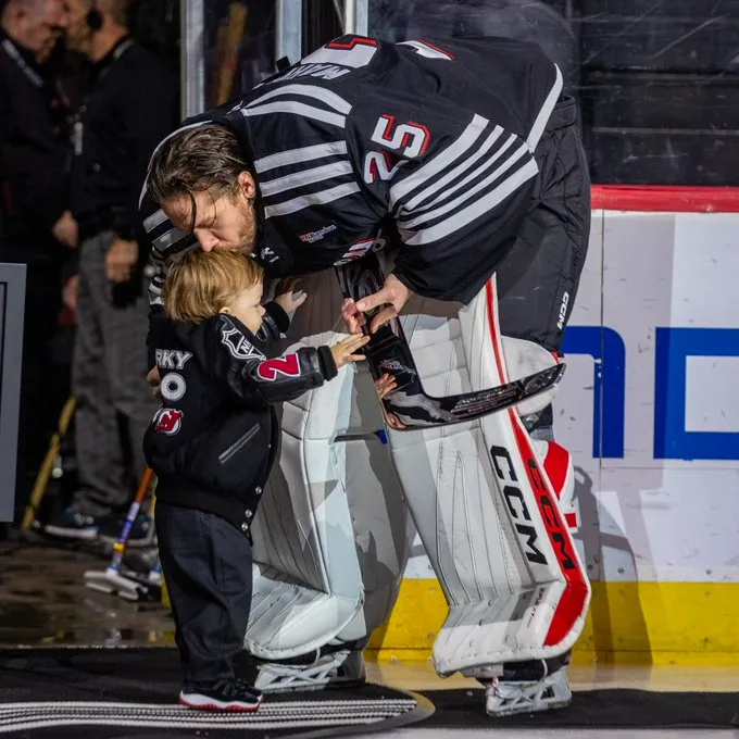 Jacob Markstrom and his son on the ice after receiving silver stick